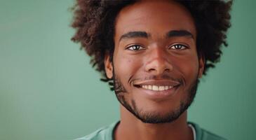 Smiling Black Man With Dreadlocks on Green Background photo