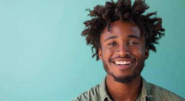 Smiling Black Man With Dreadlocks Against Blue Background photo