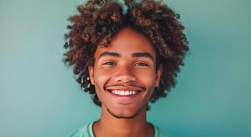Smiling Black Man With Dreadlocks Against Blue Background photo