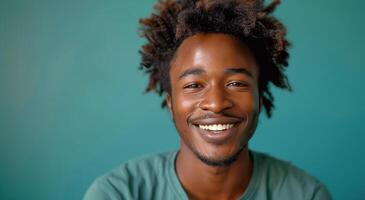 Smiling Black Man With Dreadlocks Against Blue Background photo