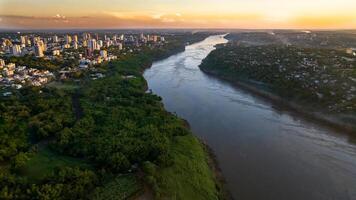 Border between Brazil and Paraguay and connects Foz do Iguacu to Ciudad del Este. Ponte da Amizade in Foz do Iguacu. Aerial view of the Friendship Bridge with Parana river. photo