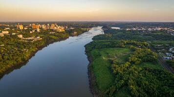 Border between Brazil and Paraguay and connects Foz do Iguacu to Ciudad del Este. Ponte da Amizade in Foz do Iguacu. Aerial view of the Friendship Bridge with Parana river. photo