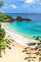 Fernando de Noronha, Brazil. Aerial view of Sancho Beach on Fernando de Noronha Island. View without anyone on the beach. Trees and plants around. photo