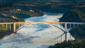 Border between Brazil and Paraguay and connects Foz do Iguacu to Ciudad del Este. Ponte da Amizade in Foz do Iguacu. Aerial view of the Friendship Bridge with Parana river. photo