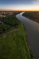 Border between Brazil and Paraguay and connects Foz do Iguacu to Ciudad del Este. Ponte da Amizade in Foz do Iguacu. Aerial view of the Friendship Bridge with Parana river. photo