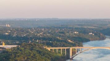 Border between Brazil and Paraguay and connects Foz do Iguacu to Ciudad del Este. Ponte da Amizade in Foz do Iguacu. Aerial view of the Friendship Bridge with Parana river. photo