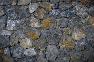 Wall of stones as a texture for background photo