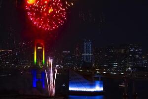 A night fireworks near Rainbow bridge at the urban city in Tokyo long shot photo