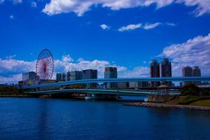 A ferris wheel at the amusement park in Odaiba Tokyo daytime wide shot photo
