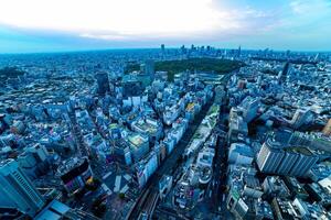 A dusk panoramic cityscape at Shibuya area high angle wide shot photo