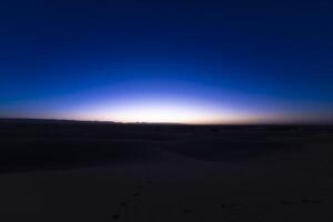 A dawn of desert at Mhamid el Ghizlane in Morocco wide shot photo