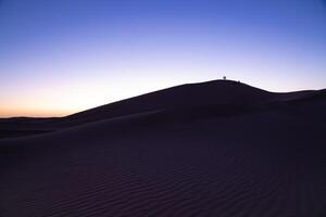 A dusk of panoramic sand dune at Mhamid el Ghizlane in Morocco wide shot photo