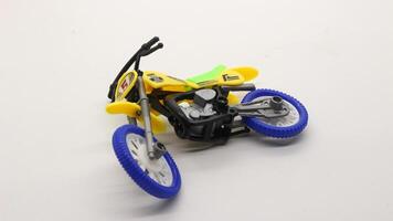 Yellow dirt bike toy isolated photo