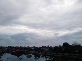 View of the sky with bright clouds on the lake photo