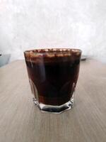 Close up view of Black coffee in glass photo