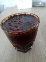 Close up view of Black coffee in glass photo