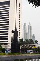 View of the city of Jakarta from a height, General Sudirman statue photo