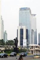 View of the city of Jakarta from a height, General Sudirman statue photo