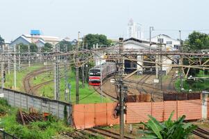 Commuter Line or electric train in Jakarta in train shed photo