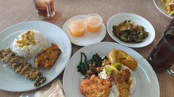 Rice and side dishes served at Padang restaurants photo