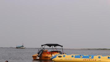 View of the sea, where you can see small islands and ships and banana boats photo