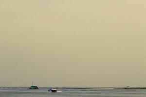 View of the sea, where you can see small islands and ships and banana boats photo