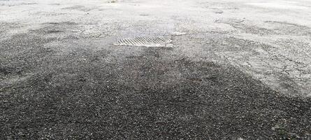 Asphalt road with uneven texture photo