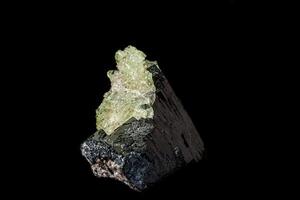 Macro stone Hyalite mineral, tourmaline Sherl, smoky quartz on a black background photo