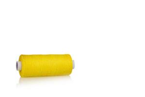 skein of thread yellow colors macro on a white background photo