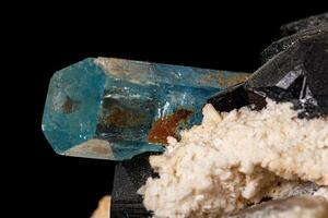 Macro stone mineral tourmaline aquamarine with a black background photo