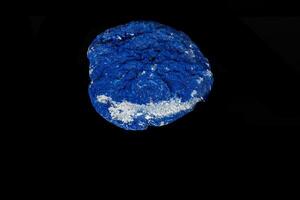 Macro mineral stone Azurite in siltstone against black background photo