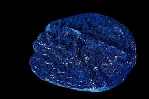 Macro mineral stone Azurite in siltstone against black background photo