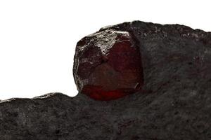 Macro mineral stone Garnet in rock on a white background photo