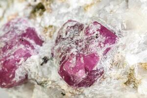 Macro mineral stone Ruby in rock on white background photo