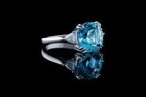 Beautiful gold ring with aquamarine and diamonds on a black background photo