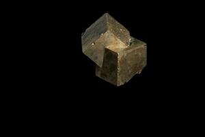 Macro mineral stone Pyrite on a black background photo