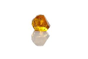 Macro yellow diamond mineral stone on white background photo