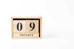 Wooden calendar January 09 on a white background photo