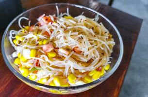 Dish of glass noodles with corn onions and tomatoes Mexico. photo