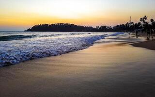 Beautiful colorful sunset on the beach Mirissa Beach Sri Lanka. photo