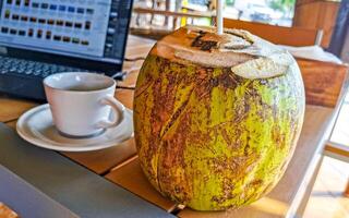 Tropical coconut with straw on the table Puerto Escondido Mexico. photo