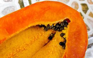 Half papaya in hand with background in Mexico. photo