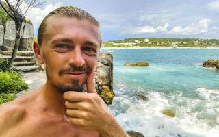 Selfie with rocks cliffs view waves beach Puerto Escondido Mexico. photo