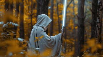 A cloaked figure holds a glowing rod in a mystical autumn forest photo