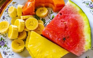 Plate with selected fruits papaya banana watermelon pineapple Costa Rica. photo