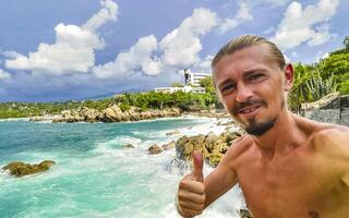 Selfie with rocks cliffs view waves beach Puerto Escondido Mexico. photo