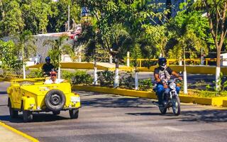 Puerto Escondido Oaxaca Mexico 2023 Yellow car vehicle transportation retro in city town Mexico. photo