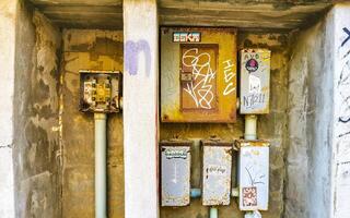 Puerto Escondido Oaxaca Mexico 2023 Old broken electricity meters on the wall in Mexico. photo