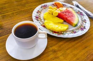 Plate with selected fruits and cup of coffee Costa Rica. photo