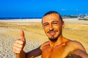 Selfie with rocks cliffs view waves beach Puerto Escondido Mexico. photo